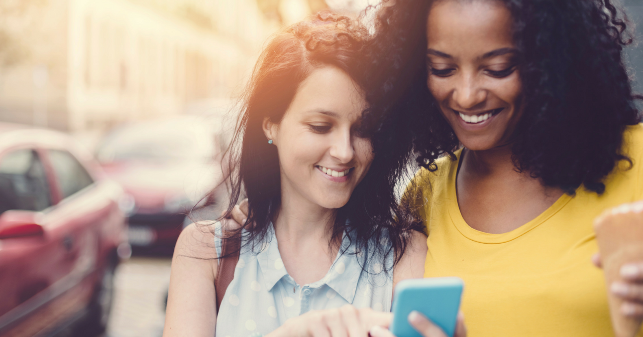 Two friends looking at a phone