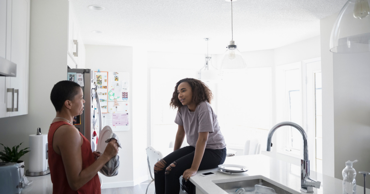 Mother and daughter talk in the kitchen