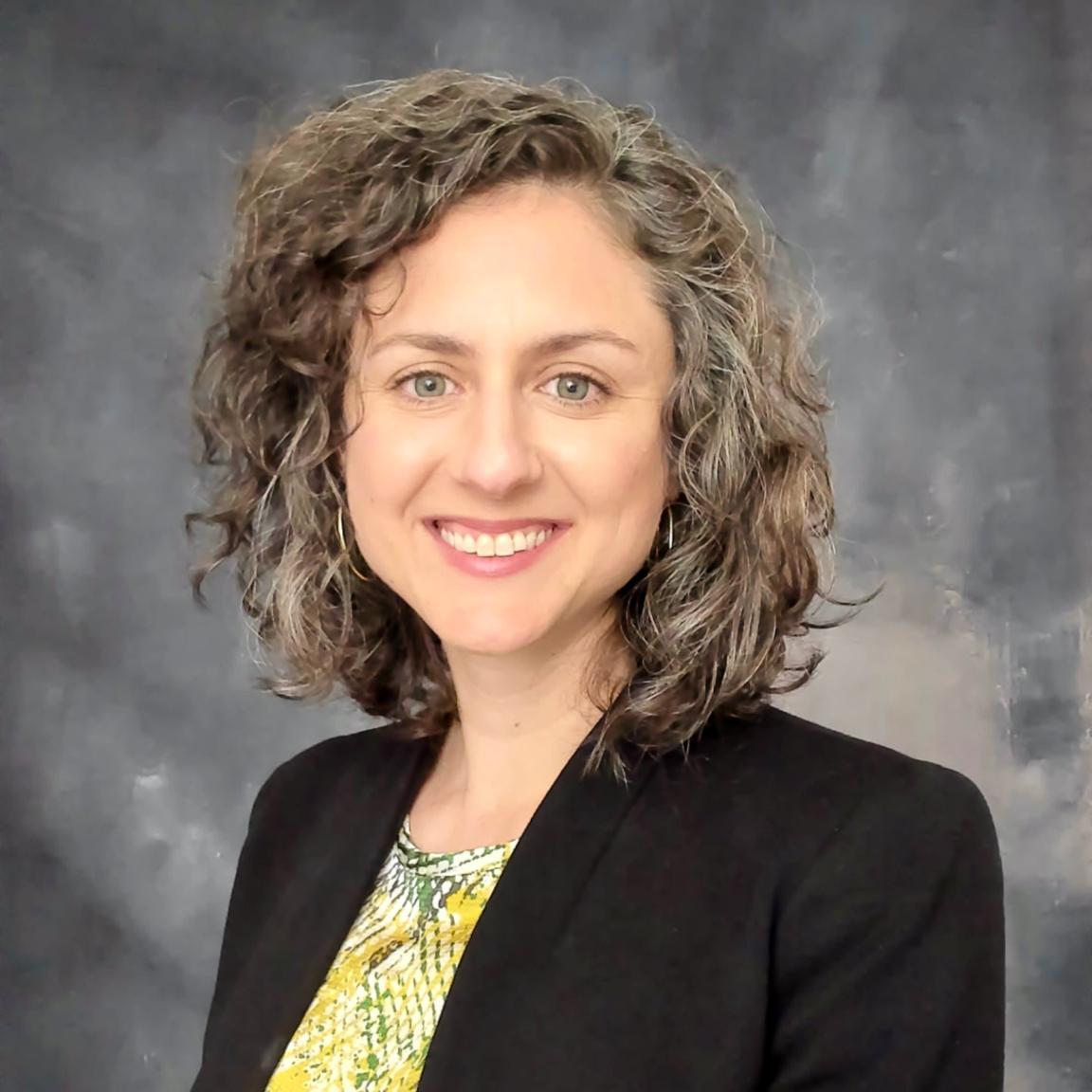 A headshot of Riley Steiner, Senior Director of Research and Evaluation at Power to Decide.