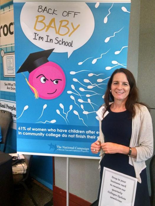 A photo of Andrea Kane next to a poster reading, "Back off baby I'm in school!"