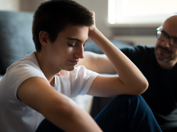 mentor talking with teenage boy 