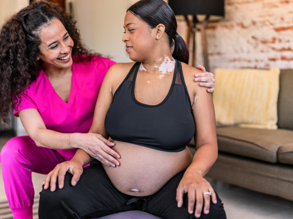Doula assisting pregnant woman